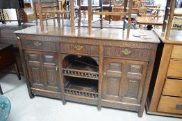 A late 19th or early 20th Century carved oak sideboard, width approx. 177cm