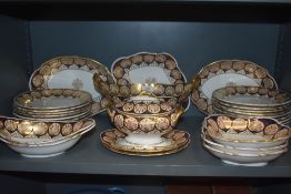 A Wedgwood part dinner service decorated with a blue and gilt shell banding with a central gilt