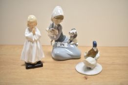 A Royal Doulton bone china figurine 'Bedtime' HN 1978 sold together with a Lladro porcelain group '