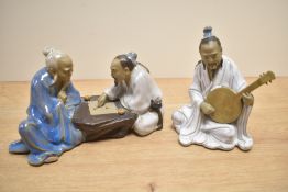 Two 20th Century Chinese Mudmen figures depicting a banjo player and the other a game of checkers.