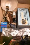 A selection of camera flashes, light meters, bellows etc