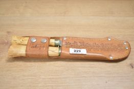 A vintage Puukko and fillet knife in a leather carrying case.