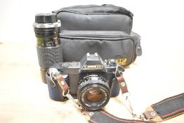 A Canon T50 camera with cover and carry case