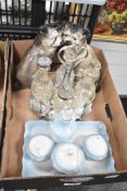 A light blue and white porcelain condiment set sold together a pair of dogs in the style of