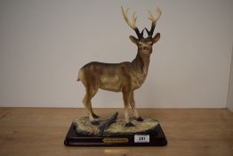 A large resin study of a Buck Deer, on plinth, measuring 30cm tall complete with box. Damage to