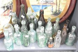 A selection of twenty four antique glass Codd necked bottles including names Nutall & Co Blackburn