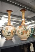 An attractive pair of Royal Doulton Slaters Patent stoneware vases, having floral designs to mid-