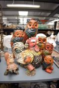 A group of five wooden carved graduating owls, the largest measuring 42cm tall, sold together with a