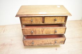 A vintage oak novelty size chest of drawers, measures 28cm x 14cm x 20cm.