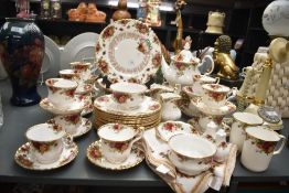A Royal Albert 'Old Country Rose' pattern dinner/tea service having gilt edging and floral