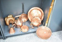 An assortment of copper items to include bed-warming pan, skimmer, measure and kettle etc.