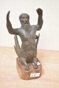 A mythical sea creature having hands raised, mounted on a wooden base, h24cm