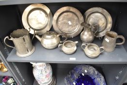 An assortment of Pewter items to include teapot and plates etc.