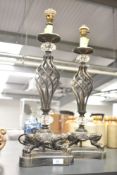 A pair of decorative painted bronze effect metal table lamps, measuring 58cm tall respectively.