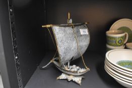 A vintage metal study depicting a Viking style boat, measures 22cm tall.