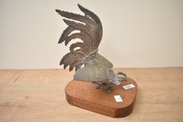 An ornamental plated fighting cock on wooden plinth, measures 26cm tall.
