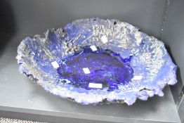 A large studio pottery dish having molten glass effect to centre, diameter measures 40cm.