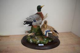 A Country Artists animal group 'Restful Days' model number CA802, on wooden plinth measuring 30cm