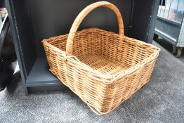 A lovely oversized woven wicker basket, possibly for timber or even a baker's boy, measures 59cm x