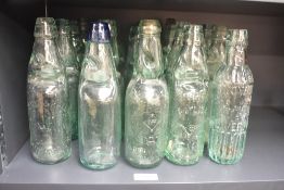 A selection of twenty antique glass Codd necked bottles including names Groves & Whitnell Hulme