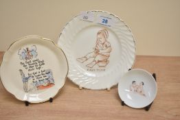 Three decorative porcelain plates, the largest having a child on chamber pot with phrase 'Easy