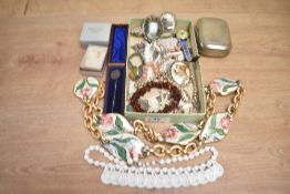 An assortment of costume jewellery, including a silver tie clip, an amber chip bracelet, faux pearls