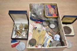 An assortment of mixed coins, medallions, pin badges etc
