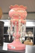 An attractive 19th century pink glass table lustre having cut glass spears/drops, gilt edging and