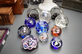 A Caithness Celebration paperweight number 100/750 sold alongside a group of ten similar glass