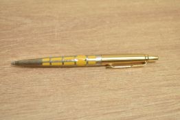 A Parker Jotter 50th Anniversary edition ballpoint pen in saffron yellow with silver filigree and