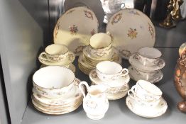 A Mintons fine bone china tea service, having gilt edge and floral patterns, to include plates, cups