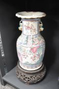 A large 19th century Chinese Famille Rose porcelain vase, having Foo dog handles and depictions of