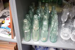 A selection of nineteen antique glass Codd necked bottles including names Brooke & Haley