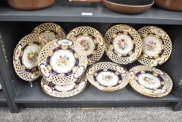 A group of Mintons bone china plates, having basket weave borders and floral designs to centre