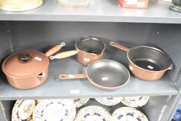 A group of four Le Creuset Cast Iron items comprising three sauce pans (one with lid) and a