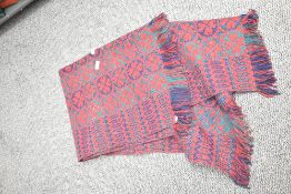 A vintage woolen blanket, in red, navy and green.