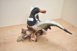 A large ceramic mallard duck study perched on logs, measuring 24cm x 42cm approximately.