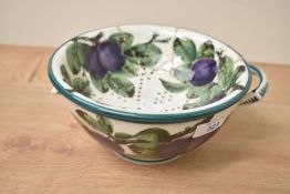 An antique Weymss pottery colander, the insert heavily damaged with glued repairs, in need of