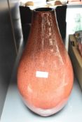A large studio pottery vase having a red mottled glaze, h42