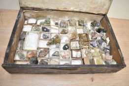 A large assortment of various mineral samples, housed in a black stained case