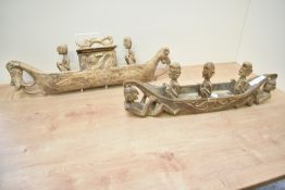 Two wooden tribal sculptures of men in boats, L53cm