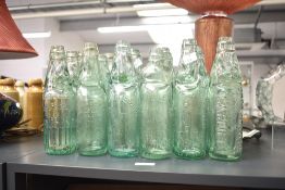 A selection of nineteen vintage glass Codd necked bottles including names Claytons Cardiff, Key