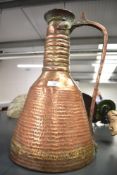 A large Eastern hand-beaten copper flagon/pitcher, measures 43cm tall.