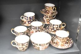 A group of Royal Crown Derby 2451 Imari pattern bone china teacups and saucers plus sugar bowl,