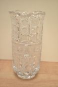 A heavy hand cut crystal vase decorated with star-cutl motifs and supported on a footed base h28.5cm