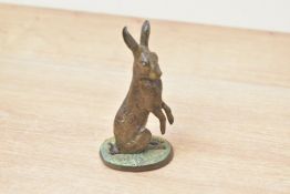 A small heavy cold-painted metal hare study, measures 10cm tall.