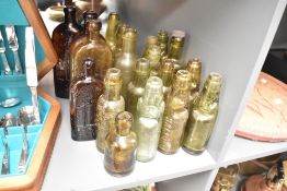 A selection of nineteen antique glass Codd necked bottles including names Warner's London and