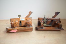 A pair of vintage wooden screw stem moulding plough planes.