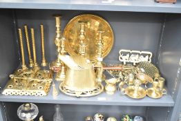 A large assortment of brass-ware to include candlesticks and horsebrasses etc.