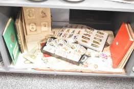 A large selection of cigarette cards and stamp albums sold together with a large scrapbook etc.